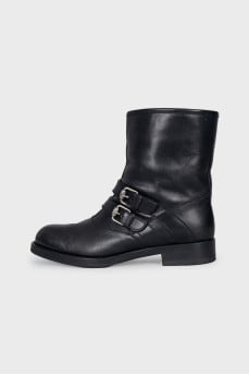 Leather boots decorated with straps