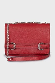 The red bag is decorated with a strap