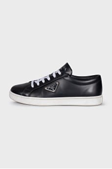 Black sneakers with a silver logo