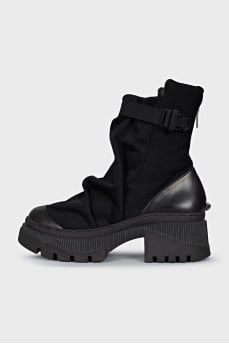 Textile and leather boots decorated with straps