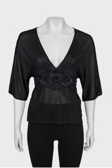 Fitted blouse decorated with beads