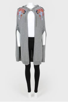 Knitted cape with drawstring hood