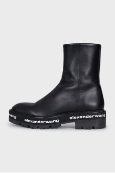 Leather boots with a logo on the sole