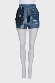 Blue denim shorts with a distressed effect