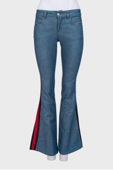 Flared blue jeans with stripes