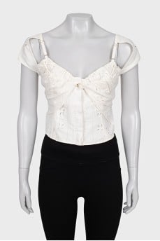Cropped top decorated with perforations