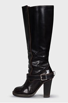 Boots decorated with a leather strap