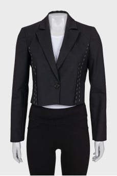 A cropped jacket decorated with chains