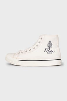 White textile sneakers with a brand logo