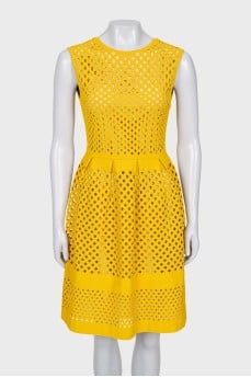 Fitted dress decorated with perforations