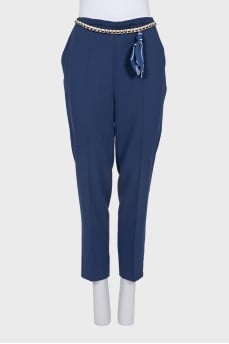 Blue trousers with removable tag decoration