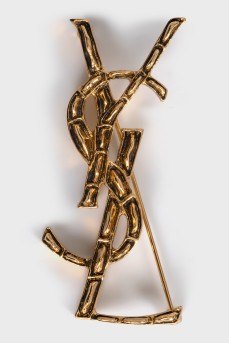 Golden relief brooch