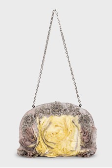 The textile bag is decorated with flowers