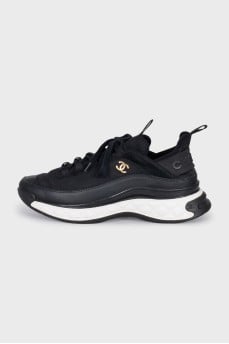 Black sneakers with a gold logo