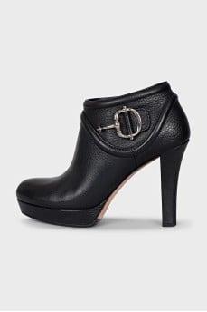 Black leather ankle boots with metal embellishments