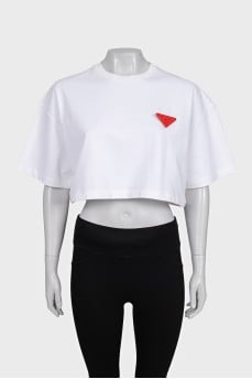 White top with a signature brooch