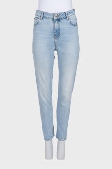Light blue jeans with a tapered fit and a button fly