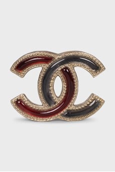 Two-tone logo-shaped brooch