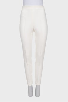 White trousers with zippers at the bottom of the legs