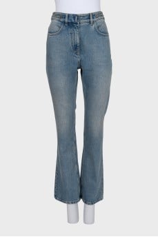Blue jeans with a silver chain tag
