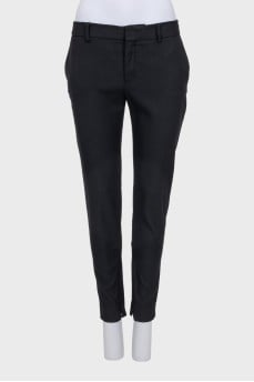 Black tapered trousers with a zip at the bottom
