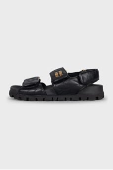 Black leather sandals with gold hardware