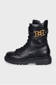 Leather boots with a gold brand logo