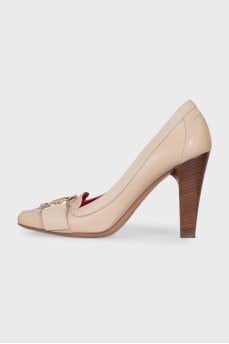 Beige leather shoes with a gold logo