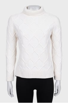Knitted white sweater with a pattern