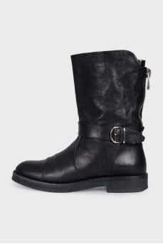 Boots decorated with leather straps