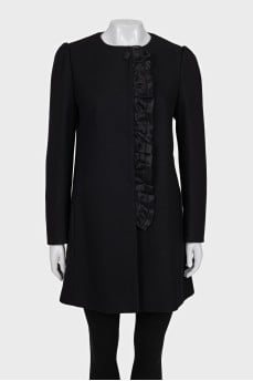 A fitted coat decorated with a frill
