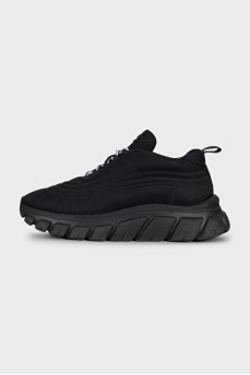 Black sneakers with a logo on a ribbed sole