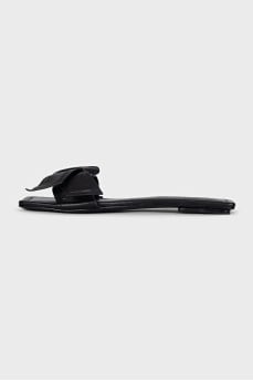 Black leather flip flops with a bow