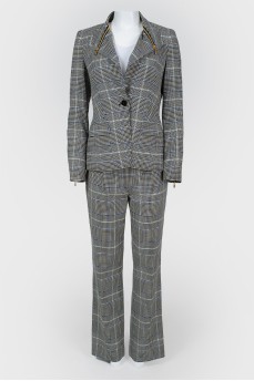 Costume jacket and trousers in a cage with a tag