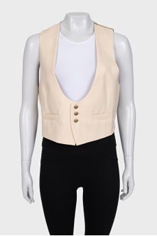 Beige vest with gold buttons and tag