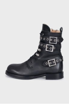 Leather boots decorated with straps