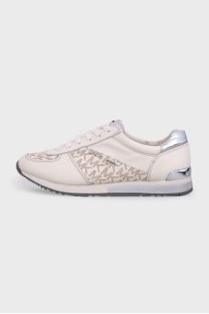 White sneakers with a signature print and logo