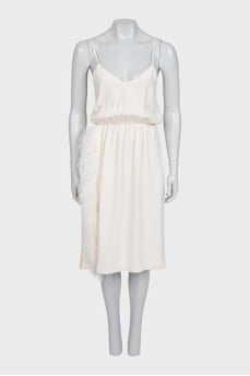 White dress with a cutout decorated with feathers