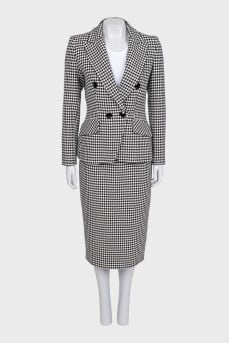 A suit consisting of a jacket, dress, and printed skirt