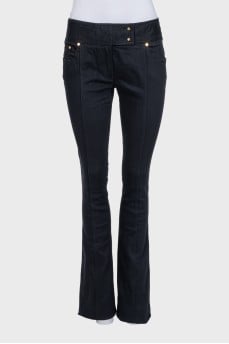 Black flared jeans with gold hardware