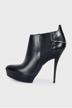 Black leather ankle boots with stiletto heels and no fastening