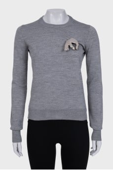 Wool jumper with a silver brooch