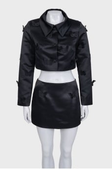 A suit consisting of a cropped jacket and a miniskirt