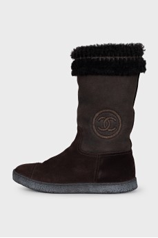 Brown boots with a brand logo