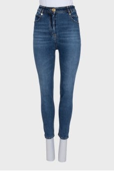Dark blue jeans with a logo button