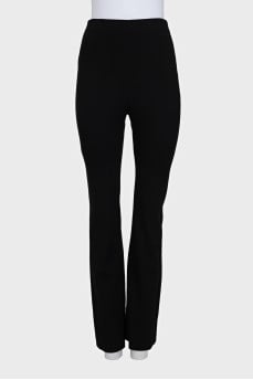 Black flared trousers with creases at the back