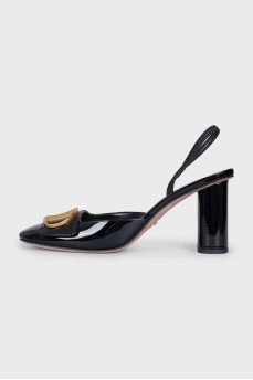 Black shoes with a gold logo