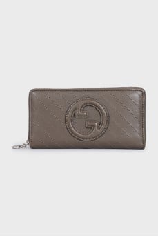 Dark green wallet with embroidered logo and tag