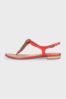 Red sandals with metallic decor