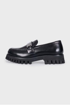 Black loafers with logo